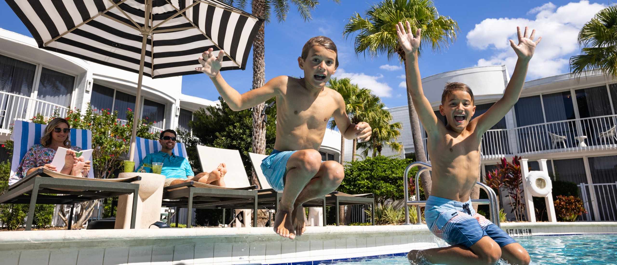 Children jumping into the resort pool at Renaissance Orlando Resort – Disney Springs® Area